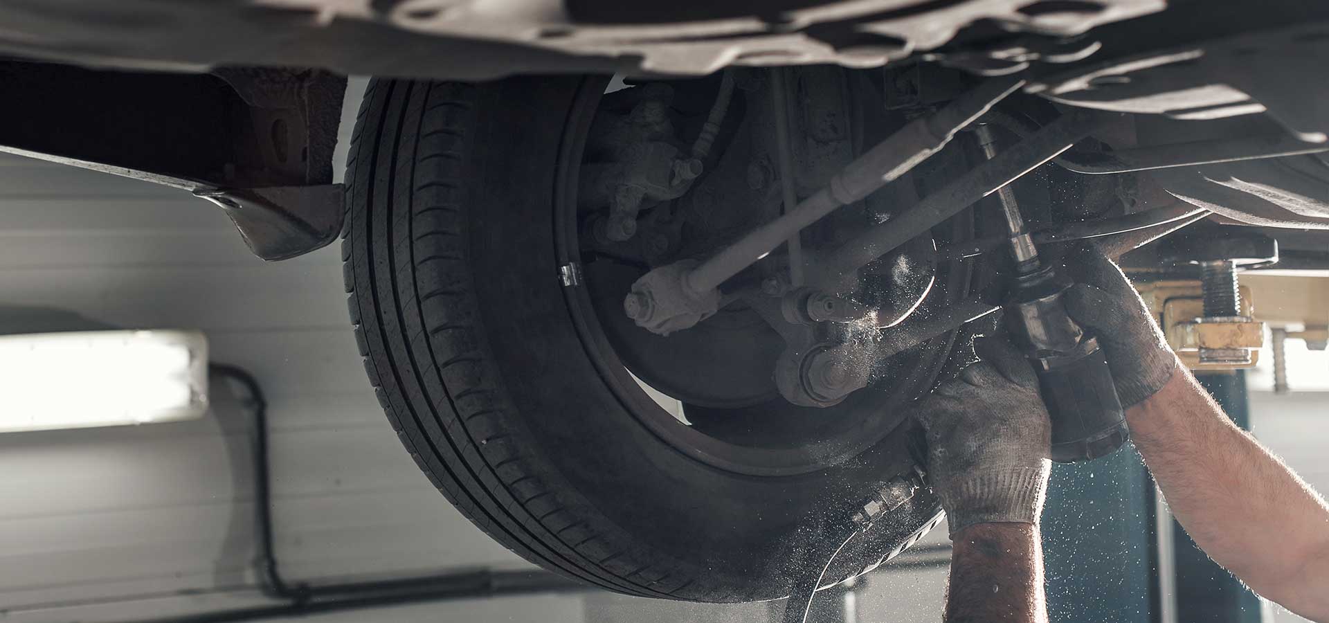 car technician working on steering and suspension